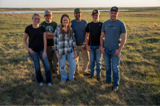 Andy Weisser's family stands in a pasture