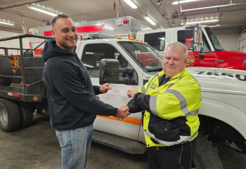 Hague Location Manager Jacques  VanLeeuwen presents check to Linton Fire Department