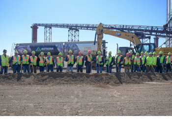 Dozens of Agtegra employees wearing hi-vis clothing hold shovels at Faulkton Feed Mill construction site.