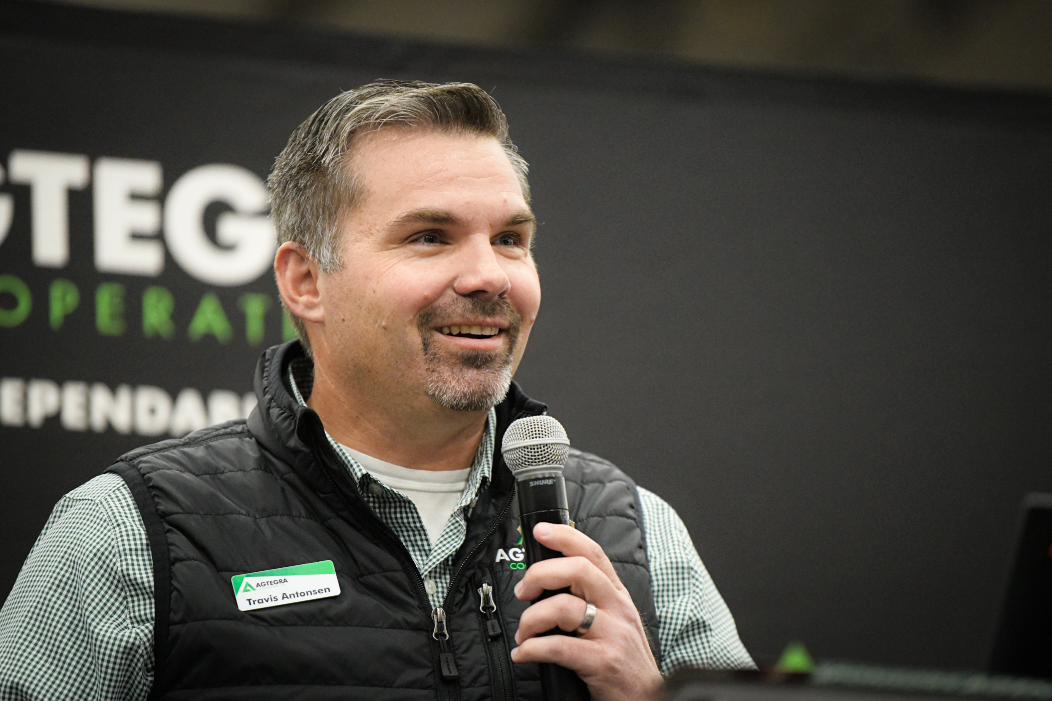 Travis Antonsen holds microphone