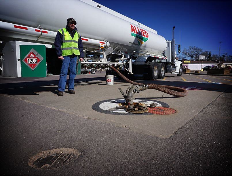 An Allied Cooperative employee near his fuel truck while filling an inground fuel tank.