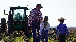 Family walking by tractor