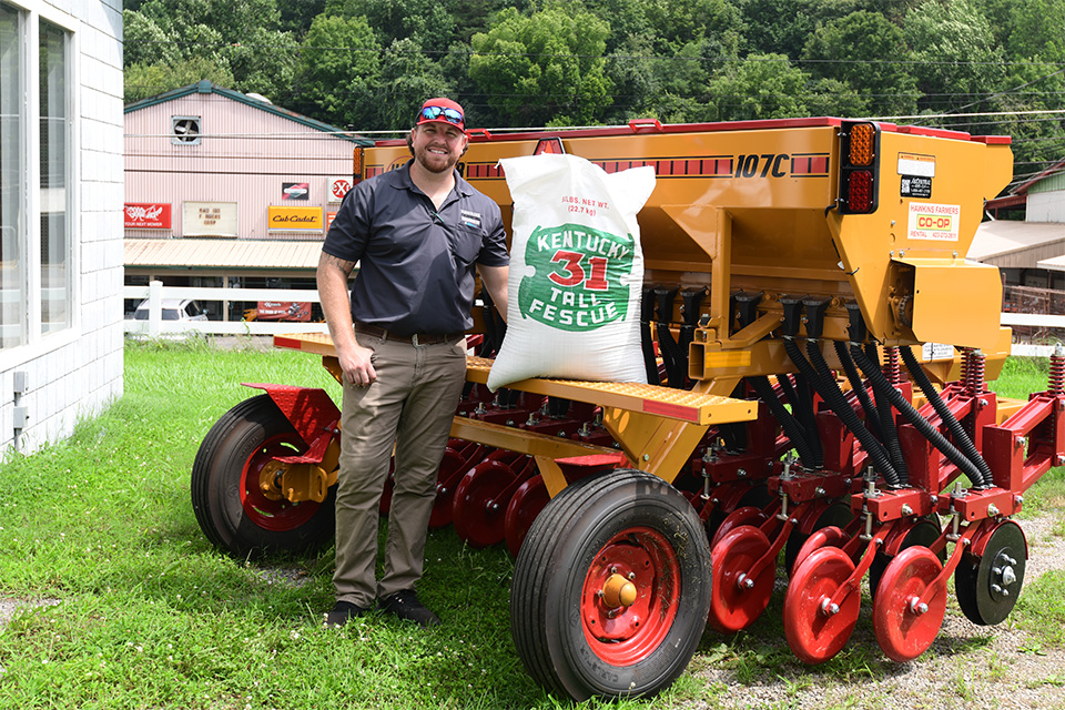 Worker standing next to bag of KY-31