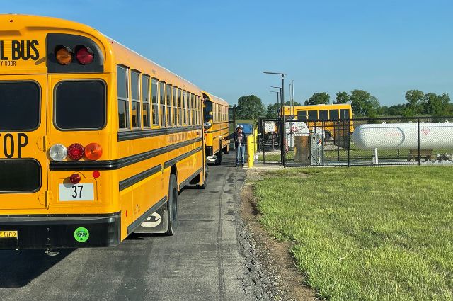 School Buses Lining Up to be Refueled from a Propane Tank