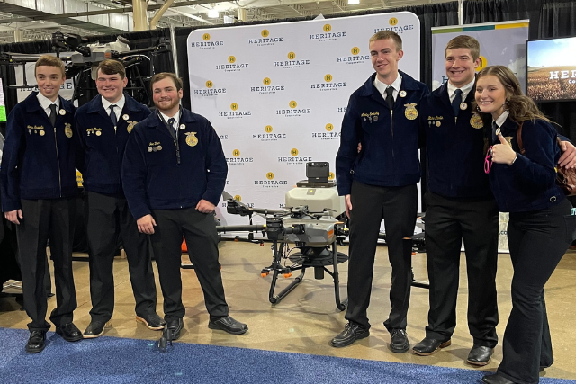 FFA Students Stand In Front of Agricultural Drone at Convention