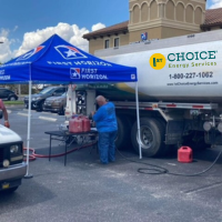 Man Filling Portable Gas Cans from Fuel Truck