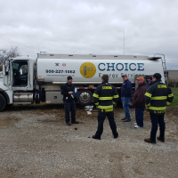 Firefighters Standing in Front of Fuel Truck Listening to Presenter