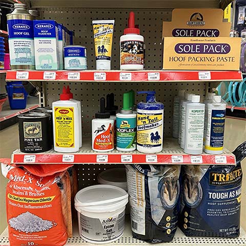 Shelves filled with various horse grooming products.