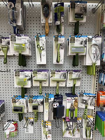 Wall of grooming supplies for pets.