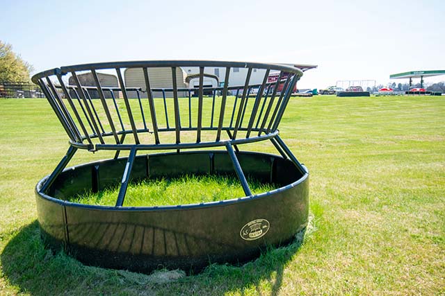 A hay feeder in a field.