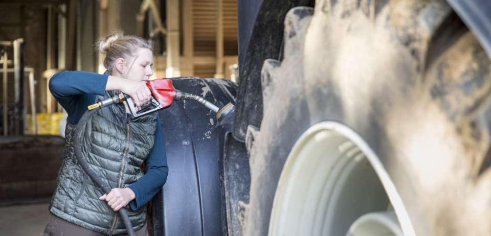 Woman Fueling Tractor Photo