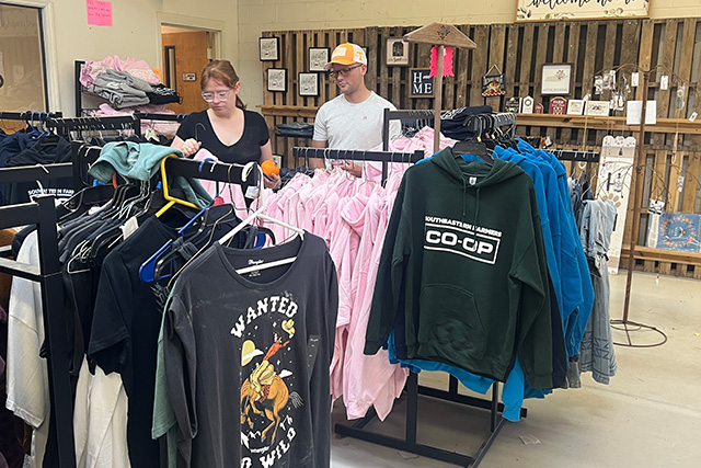 Two customers shopping in the apparel section.