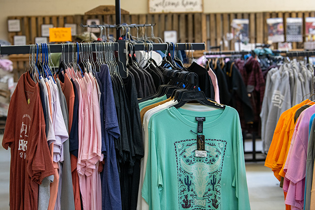 Clothing racks filled with shirts and jackets at your local co-op.