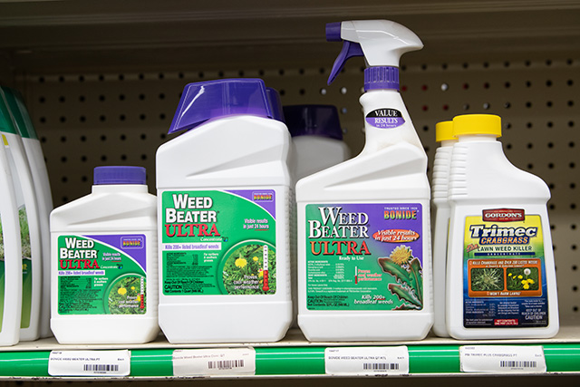 A shelf lined with Weed Beater Ultra by Bonide.