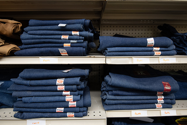 Shelves lined with stacks of Wrangler jeans.