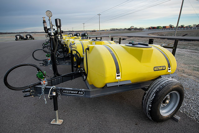 A row of Bestway sprayers outside in an empty lot.