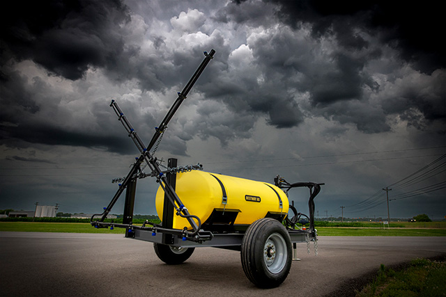 A Bestway Ag sprayer with dark clouds behind it.