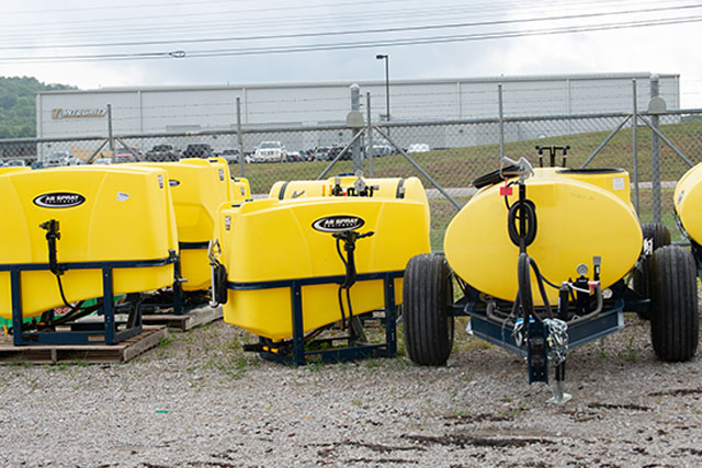 Ag Spray brand sprayers in a lot.