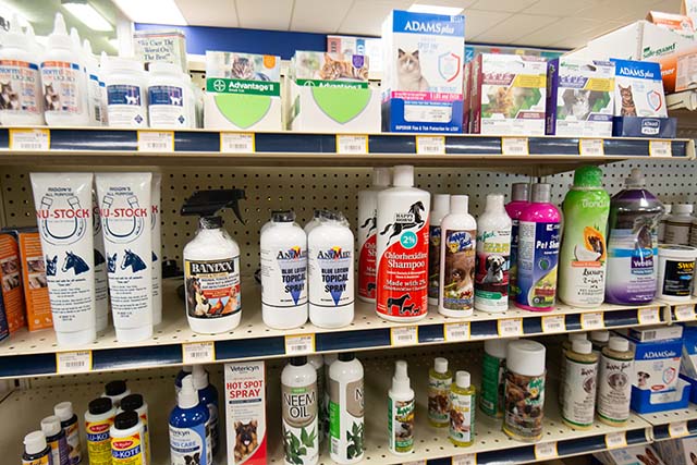 Shelves lined with various companion animal products including: flea and tick prevention, hot spot treatment, neem oil, topical sprays, shampoos and conditioners, ear care products, etc.