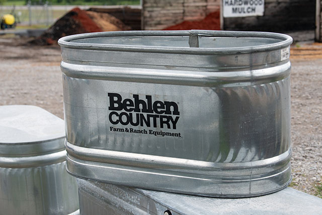 A Behlen stock tank  on top of other stock tanks.