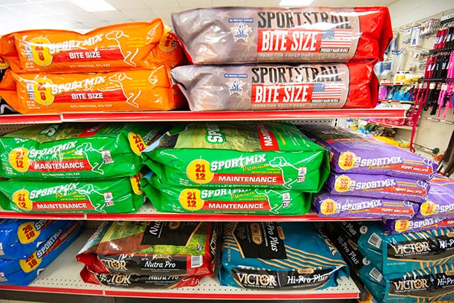 Shelves of various bags of dog food by the brands Sportmix and Victor