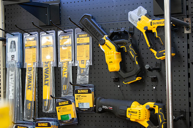 A hanging display with various DeWalt saw blades and equipment.