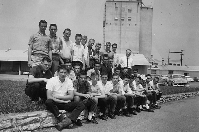 Co-op employees sitting outside of the feed mill in LaVergne