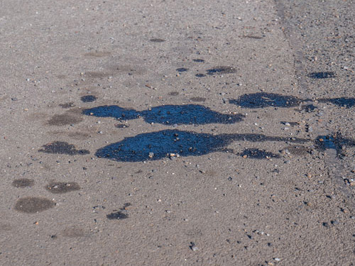 Oil puddles on concrete.