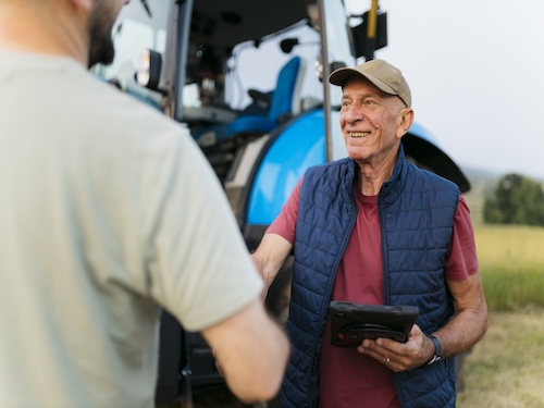 A farmer shaking hands with a customer
