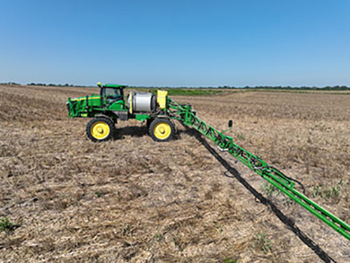 A tractor driving through a field.