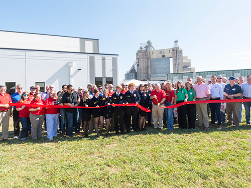 A group gathers for the ribbon cutting in front of the new Protrition Feed Mill in La Verge