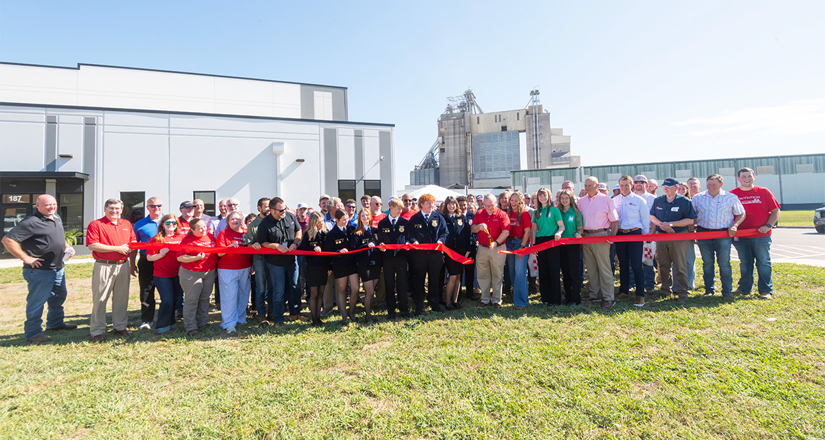 a group gathers to cut the ribbon in front of the new building in La Vergne