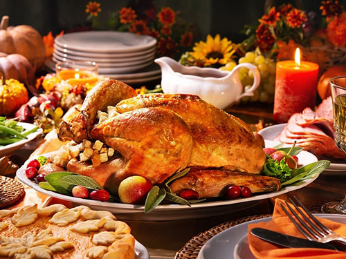 A thanksgiving feast laid out on a table for serving.