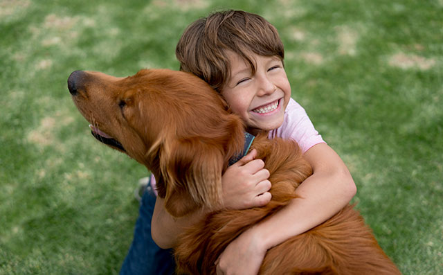 Child Hugging Dog
